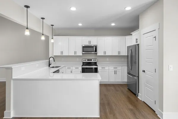 a kitchen with a sink stainless steel appliances and cabinets