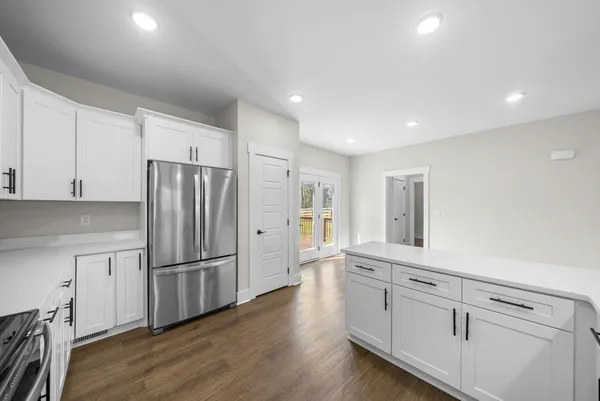 a kitchen with white cabinets and stainless steel appliances