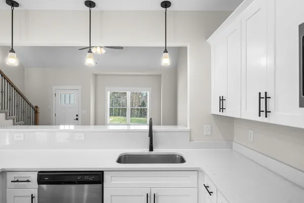 a kitchen with a sink and chandelier