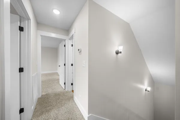 a view of a hallway with closet and wooden floor