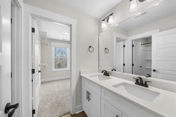 a bathroom with 2 sink tub and a mirror