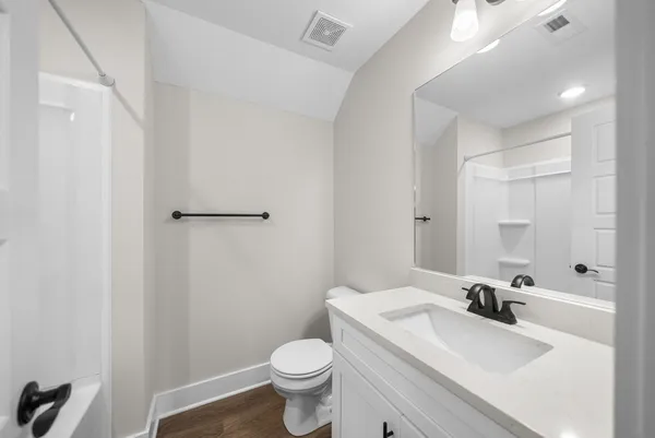 a bathroom with a bathtub a toilet and a shower