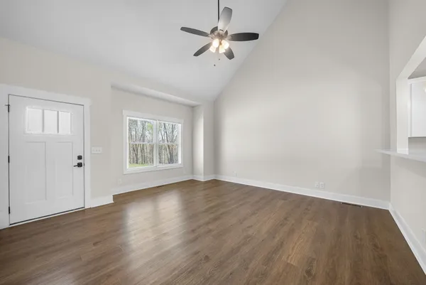 wooden floor in an empty room with a window