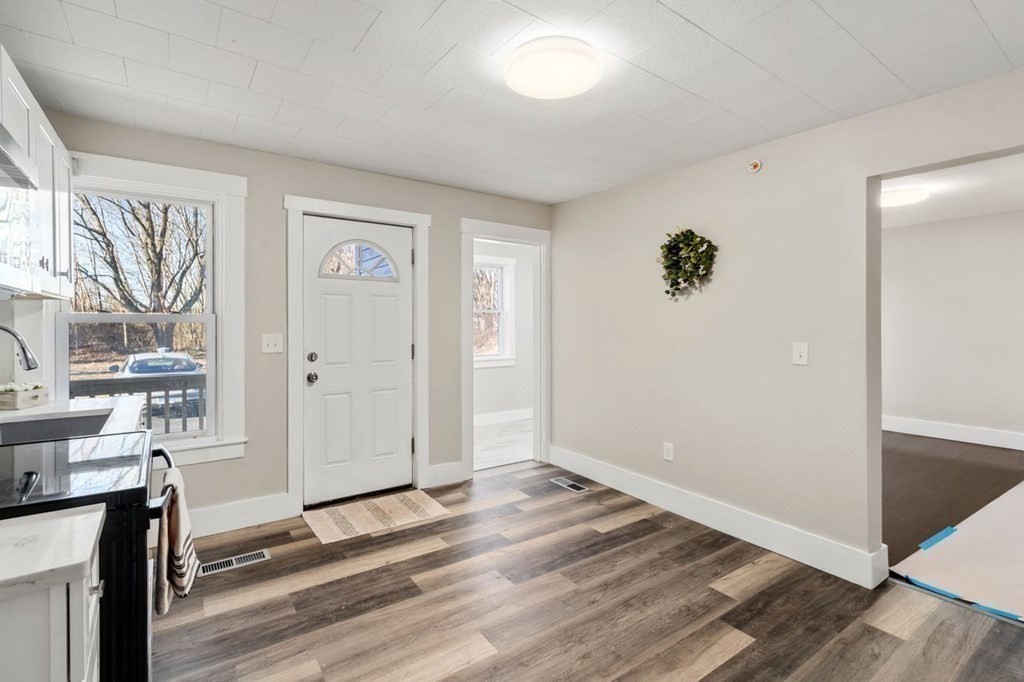 35-41 Watch Street Rochdale, MA 01542 - Photo 11 of 42 an empty room with a fireplace and windows