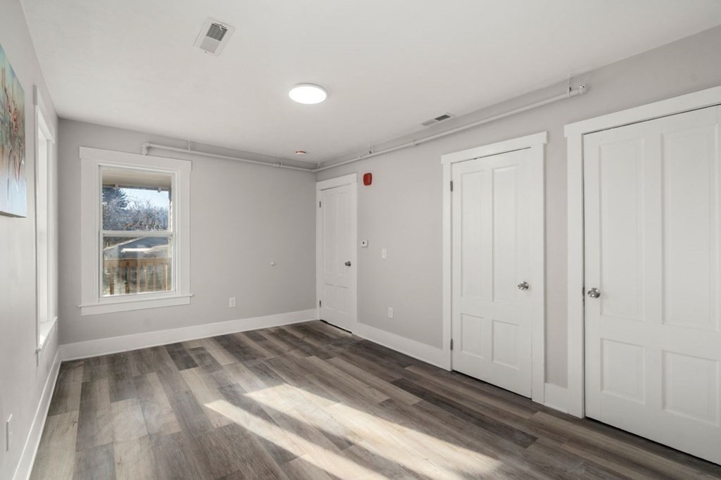 35-41 Watch Street Rochdale, MA 01542 - Photo 12 of 42 a view of an empty room with wooden floor and a window