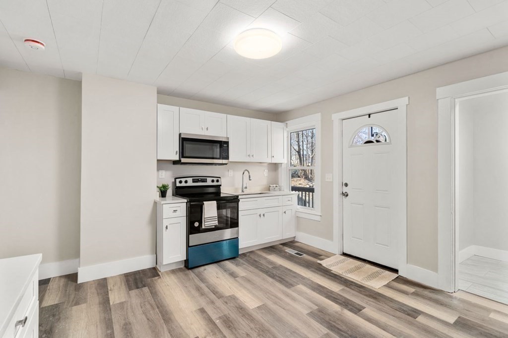 35-41 Watch Street Rochdale, MA 01542 - Photo 14 of 42 a kitchen with stainless steel appliances granite countertop a refrigerator and a stove top oven