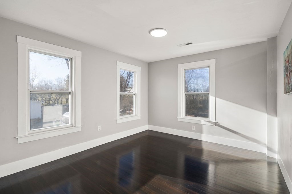 35-41 Watch Street Rochdale, MA 01542 - Photo 15 of 42 a view of an empty room with wooden floor and a window
