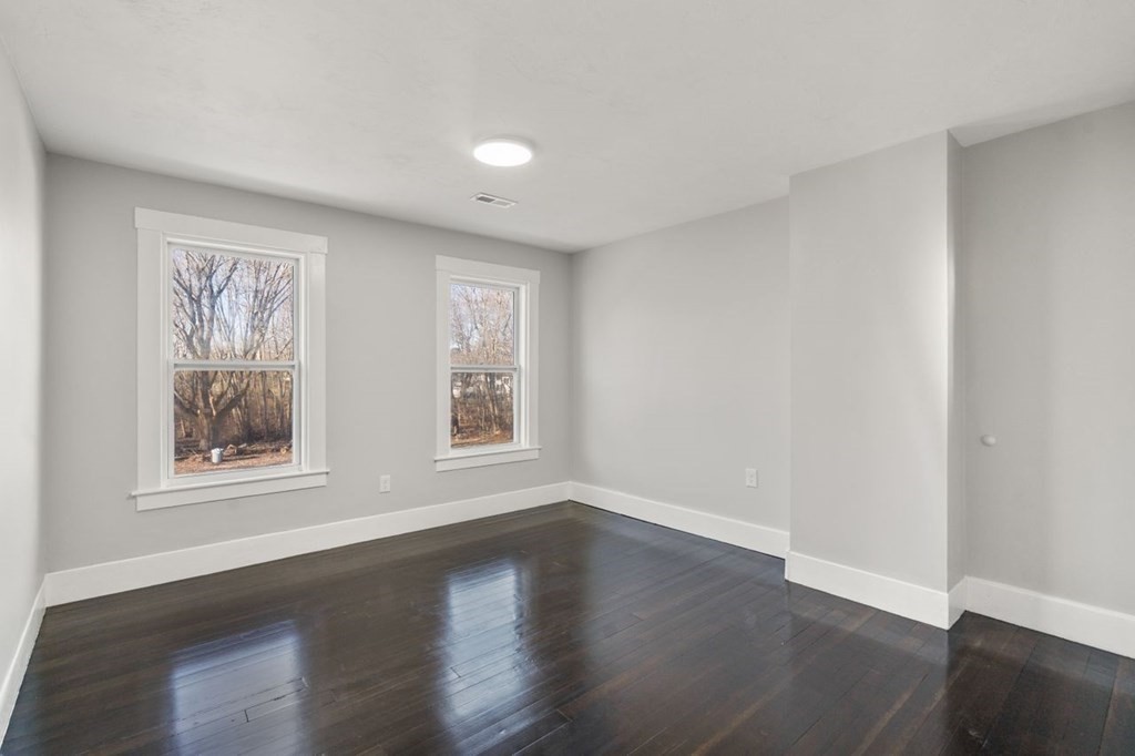 35-41 Watch Street Rochdale, MA 01542 - Photo 16 of 42 a view of an empty room with wooden floor and a window