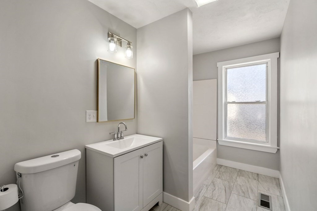 35-41 Watch Street Rochdale, MA 01542 - Photo 17 of 42 a bathroom with a toilet sink and mirror