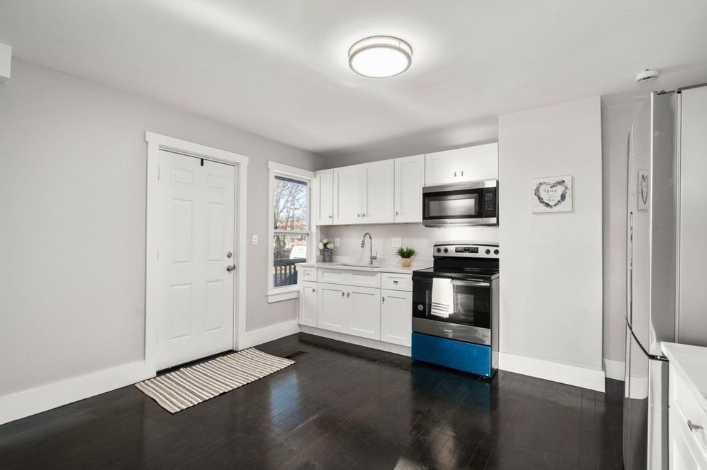 35-41 Watch Street Rochdale, MA 01542 - Photo 22 of 42 a kitchen with stainless steel appliances a stove a microwave and cabinets