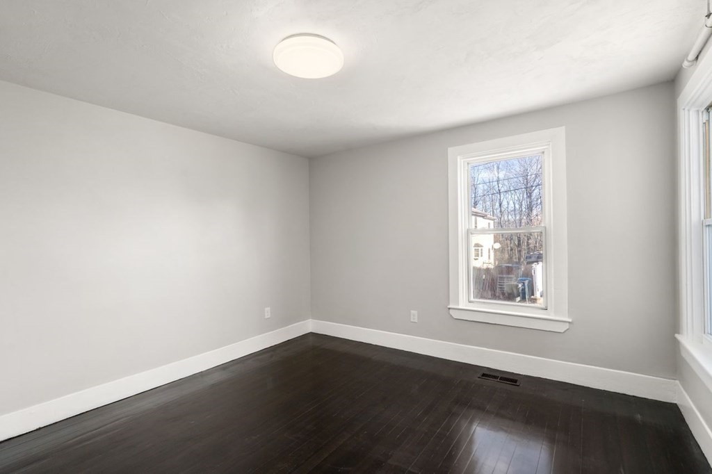 35-41 Watch Street Rochdale, MA 01542 - Photo 26 of 42 an empty room with wooden floor and windows