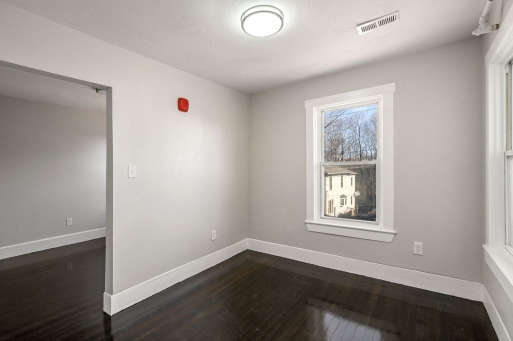 35-41 Watch Street Rochdale, MA 01542 - Photo 30 of 42 a view of an empty room with wooden floor and a window