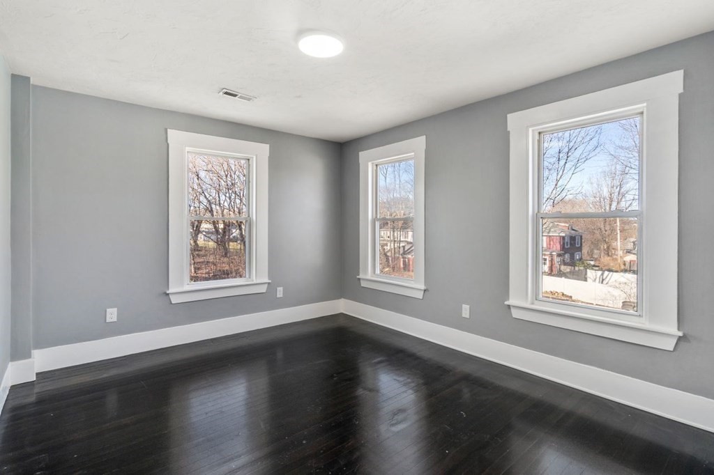 35-41 Watch Street Rochdale, MA 01542 - Photo 35 of 42 a view of an empty room with wooden floor and a window