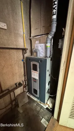 a bathroom with a granite countertop sink toilet and mirror