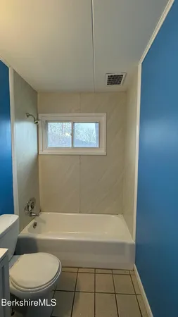 a view of a livingroom with furniture and windows