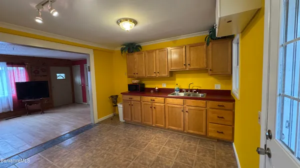a spacious bathroom with a granite countertop sink and a mirror