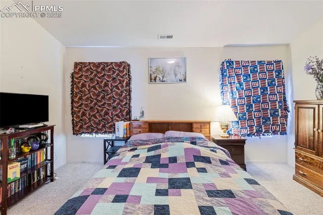 a bedroom with a bed and a night stand