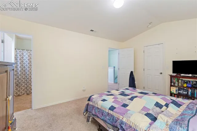 a bedroom with a bed and a television