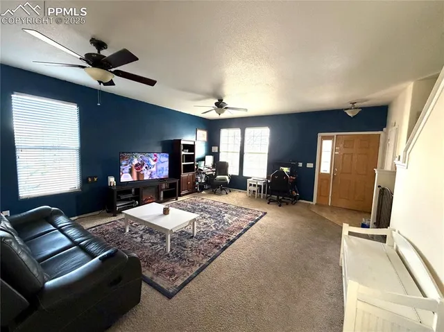 a living room with fireplace furniture and a flat screen tv