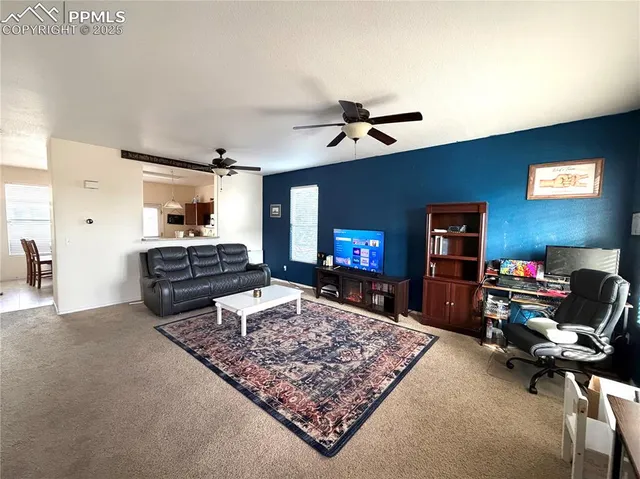 a living room with furniture and a flat screen tv