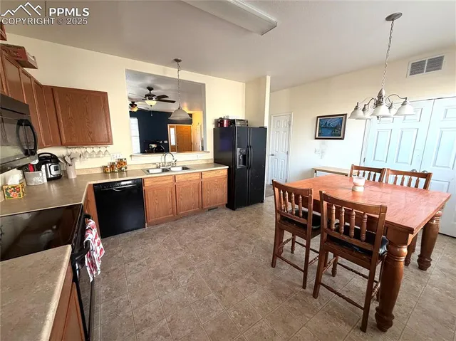 a kitchen with a table chairs refrigerator and microwave