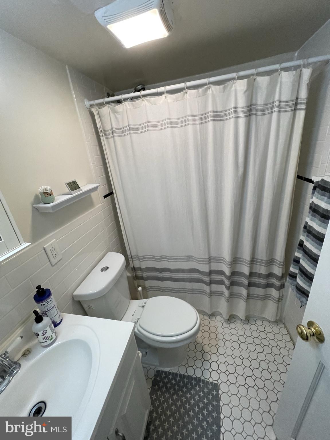 133 South 18th Street, Unit 3F Philadelphia, PA 19103 - Photo 6 of 7 a bathroom with a sink a toilet and shower curtain