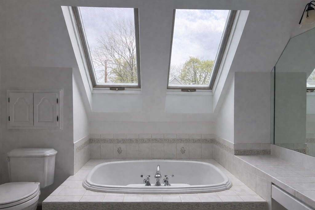 29 Boulevard Road Dedham, MA 02026 - Photo 20 of 34 a bathroom with a bathtub and toilet