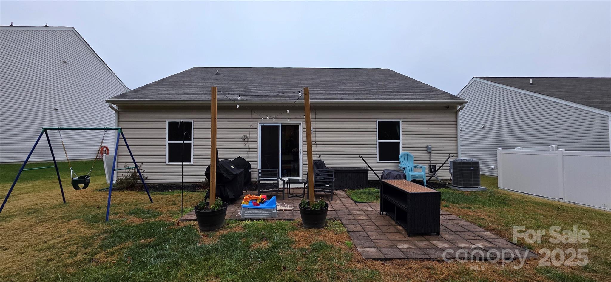 a backyard of a house with barbeque oven table and chairs