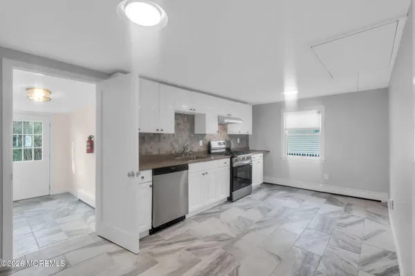 a kitchen with granite countertop a sink and a stove top oven