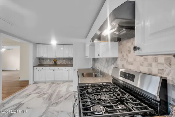 a kitchen with stainless steel appliances granite countertop a stove and a refrigerator