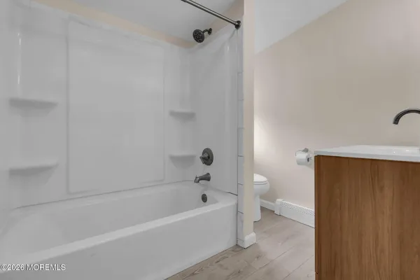 a bathroom with a bathtub and a toilet