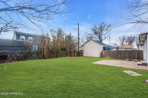 a backyard of a house with lots of green space and fountain