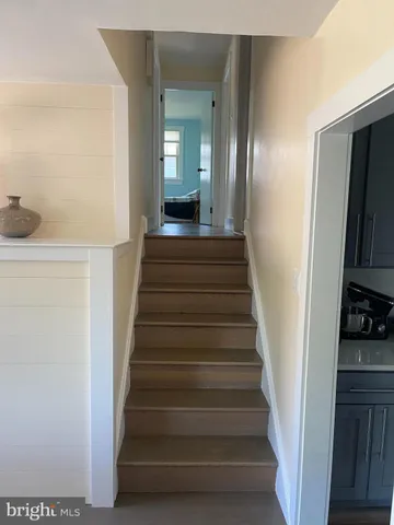 a view of a hallway with wooden floor and entryway