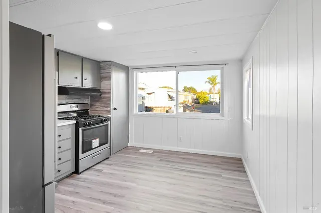 a kitchen with stainless steel appliances a stove a refrigerator and cabinets