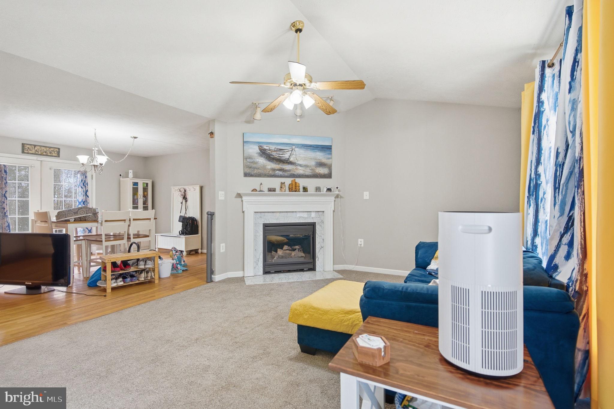 4624 Strasburg Road Strasburg, VA 22657 - Photo 5 of 31 a living room with furniture a fireplace and a chandelier
