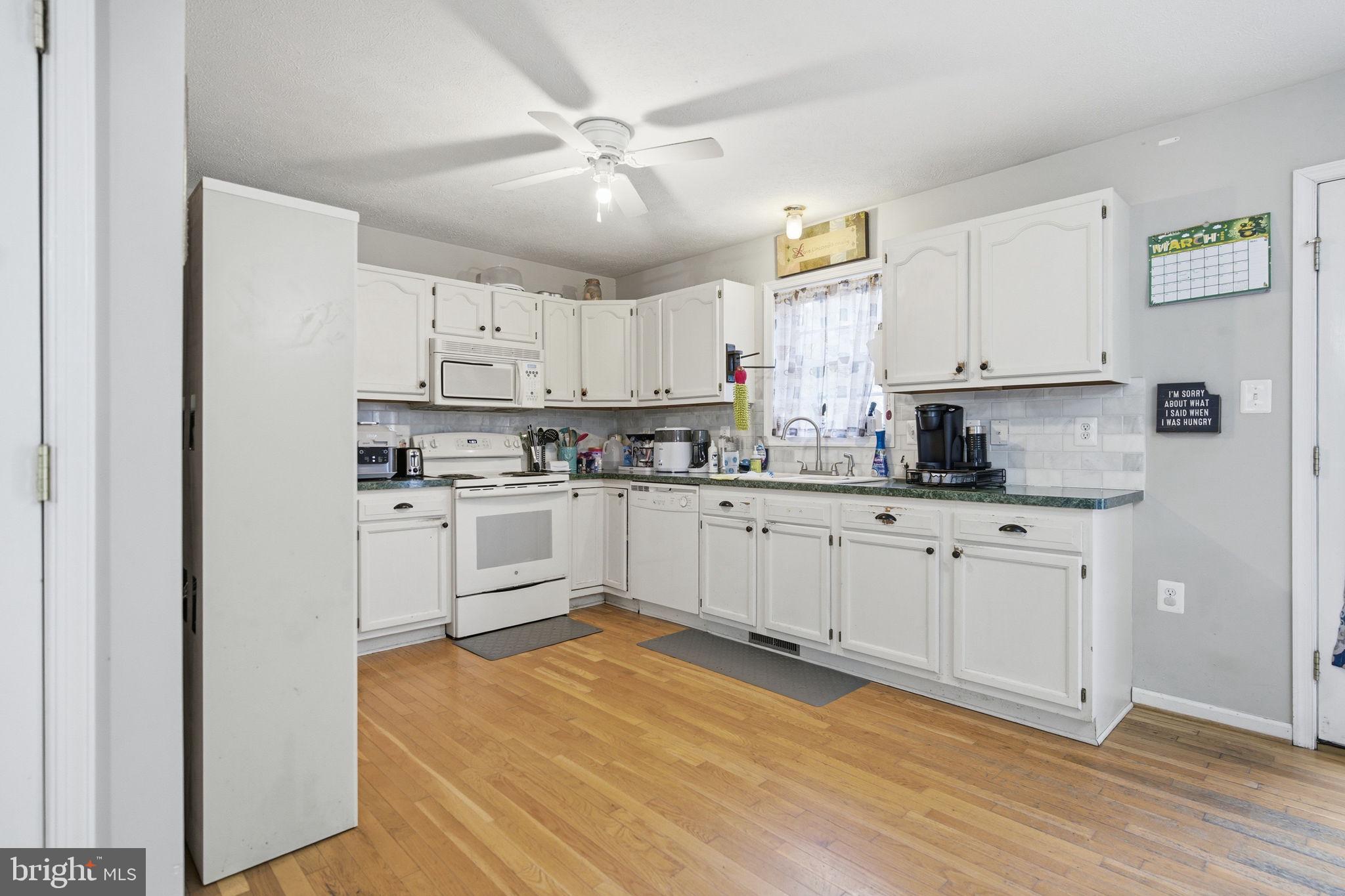 4624 Strasburg Road Strasburg, VA 22657 - Photo 9 of 31 a kitchen with stainless steel appliances white cabinets a sink a stove a refrigerator and white cabinets