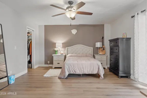 a bedroom with a bed and a ceiling fan