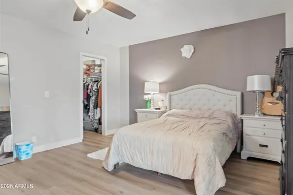 a bedroom with a bed and a chandelier