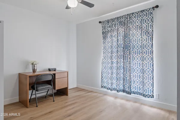 a view of a workspace with furniture and a window