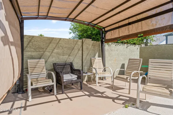 a patio with table and chairs