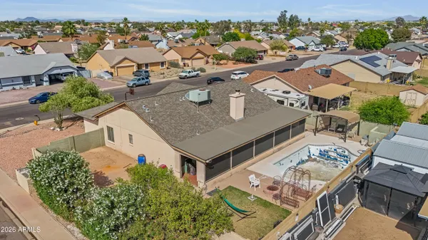 an aerial view of residential houses with outdoor space