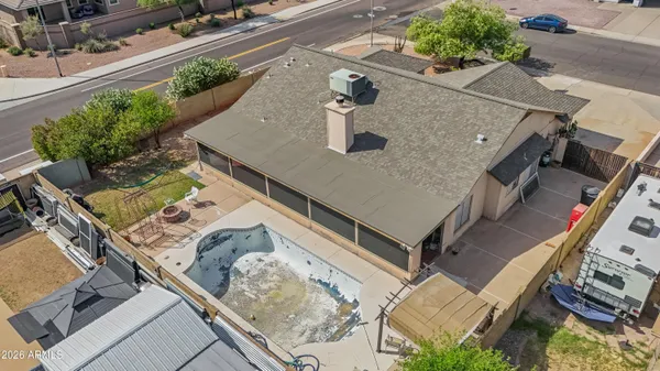 an aerial view of a house with a yard
