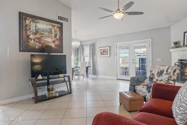 a living room with furniture a dining table and a painting on the wall