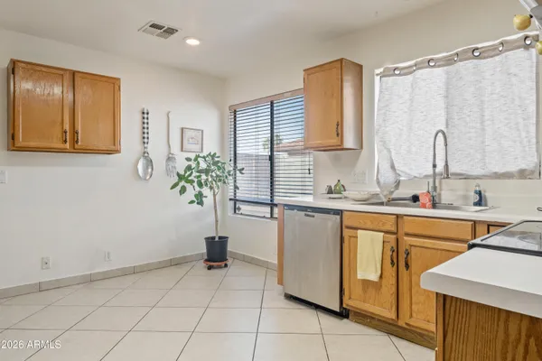 a kitchen with stainless steel appliances a sink and a refrigerator