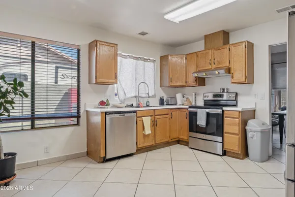 a kitchen with cabinets and steel appliances
