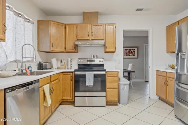 a kitchen with a stove sink and a refrigerator