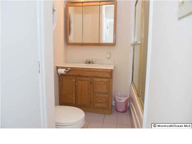 254 Lanes Pond Road Howell, NJ 07731 - Photo 15 of 16 a bathroom with a sink a toilet and a mirror