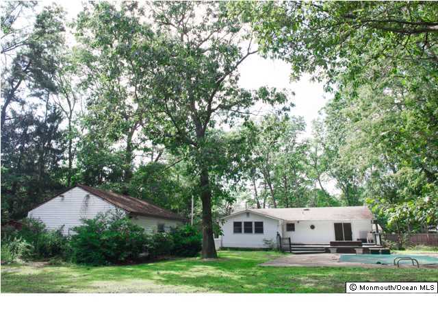 254 Lanes Pond Road Howell, NJ 07731 - Photo 16 of 16 a view of a house with a yard and large trees