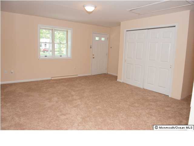 254 Lanes Pond Road Howell, NJ 07731 - Photo 3 of 16 a kitchen with white cabinets and a window