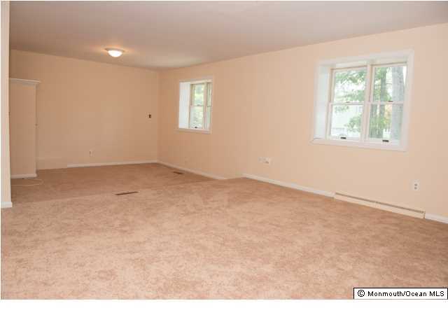 254 Lanes Pond Road Howell, NJ 07731 - Photo 4 of 16 a room with high traffic carpet with two windows